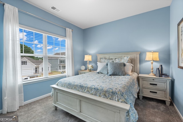 bedroom featuring carpet, baseboards, and multiple windows