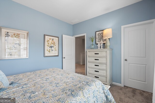 bedroom featuring carpet floors and baseboards