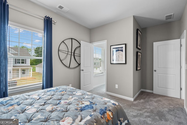bedroom with carpet flooring and baseboards