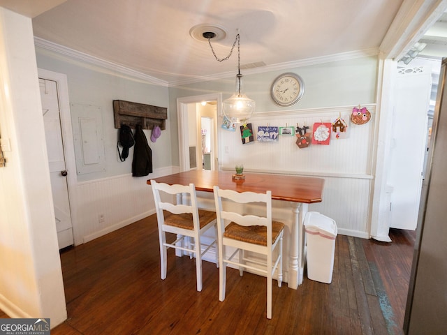 309 Mahan St, Saint Marys, GA 31558 - dining area with ornamental molding, dark wood finished floors, and wainscoting