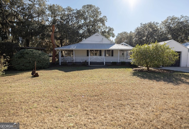 309 Mahan St, Saint Marys, GA 31558 - view of front facade featuring covered porch, a front yard, and metal roof