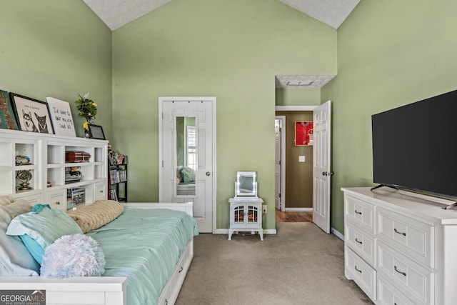 108 Wortham Dr, Buckhead, GA 30625 - bedroom with high vaulted ceiling, baseboards, and light carpet