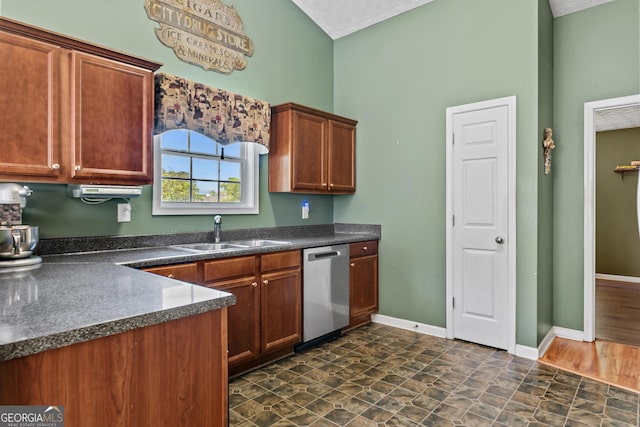 108 Wortham Dr, Buckhead, GA 30625 - kitchen with a sink, stainless steel dishwasher, dark countertops, baseboards, and brown cabinetry