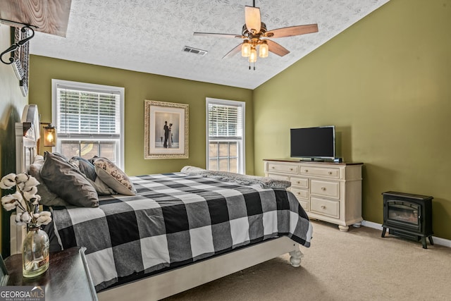 108 Wortham Dr, Buckhead, GA 30625 - bedroom featuring a wood stove, light colored carpet, multiple windows, vaulted ceiling, and baseboards