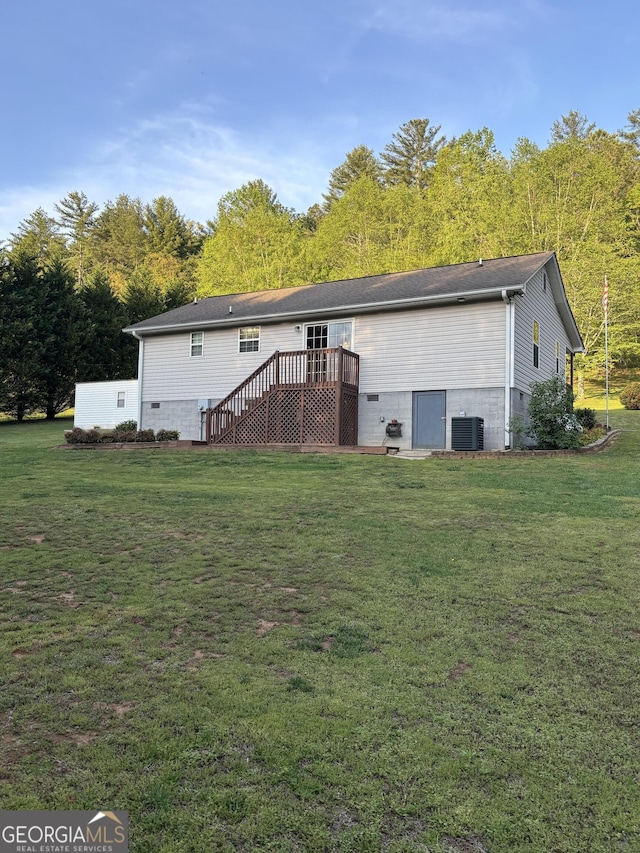 rear view of house with a deck, central AC unit, a lawn, and stairs