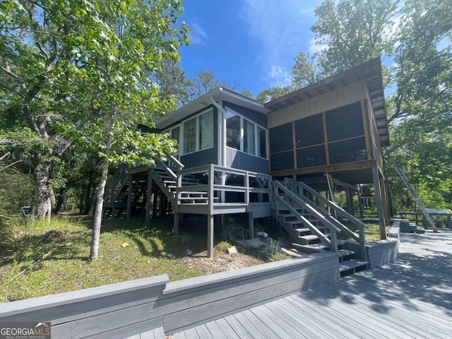 750 Warners Lndg, Hortense, GA 31543 - rear view of house featuring a sunroom, stairs, and a wooden deck