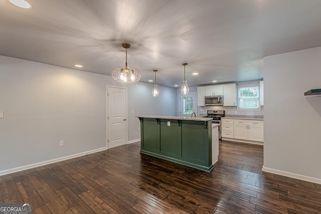 947 Rebel Forest Dr, Atlanta, GA 30315 - kitchen with stainless steel appliances, green cabinetry, white cabinets, light countertops, and dark wood-style flooring