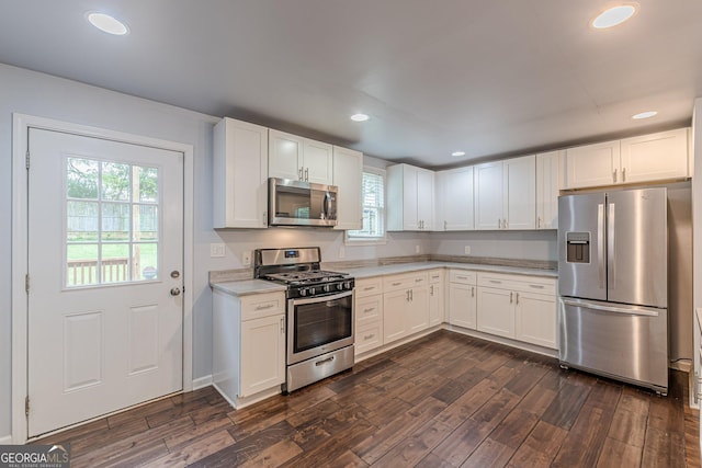 947 Rebel Forest Dr, Atlanta, GA 30315 - kitchen featuring stainless steel appliances, light countertops, dark wood finished floors, white cabinets, and recessed lighting