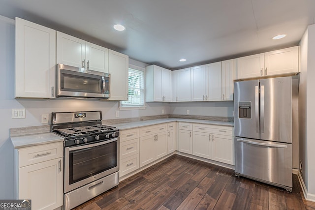947 Rebel Forest Dr, Atlanta, GA 30315 - kitchen with appliances with stainless steel finishes, dark wood-style flooring, light countertops, white cabinetry, and recessed lighting
