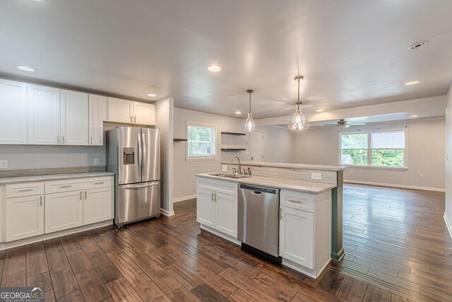 947 Rebel Forest Dr, Atlanta, GA 30315 - kitchen featuring appliances with stainless steel finishes, a sink, baseboards, a ceiling fan, and white cabinetry