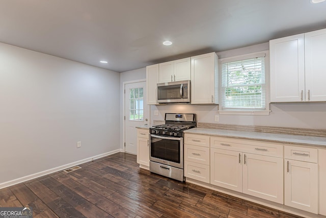 947 Rebel Forest Dr, Atlanta, GA 30315 - kitchen with stainless steel appliances, light countertops, dark wood finished floors, healthy amount of natural light, and recessed lighting