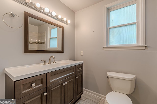 947 Rebel Forest Dr, Atlanta, GA 30315 - bathroom with plenty of natural light, baseboards, toilet, and vanity