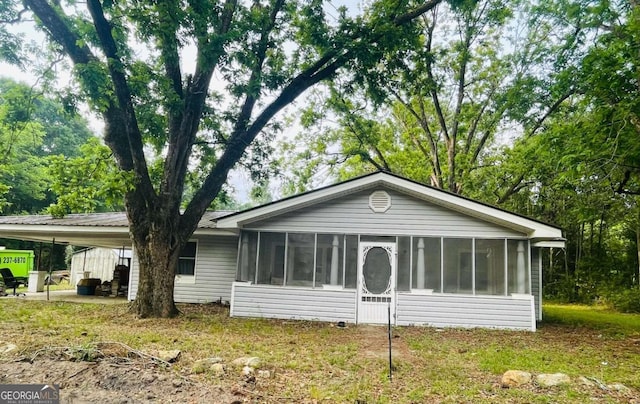 view of front of property with a sunroom