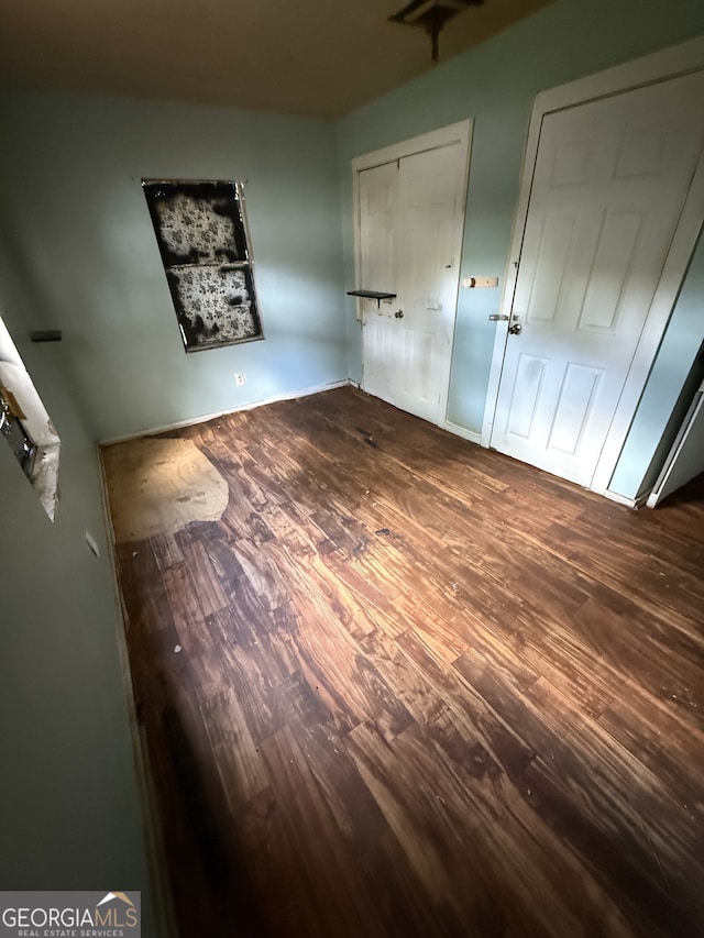 unfurnished bedroom with wood finished floors