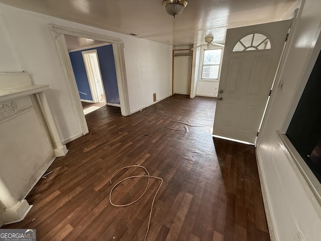 entrance foyer featuring dark wood-type flooring and baseboards