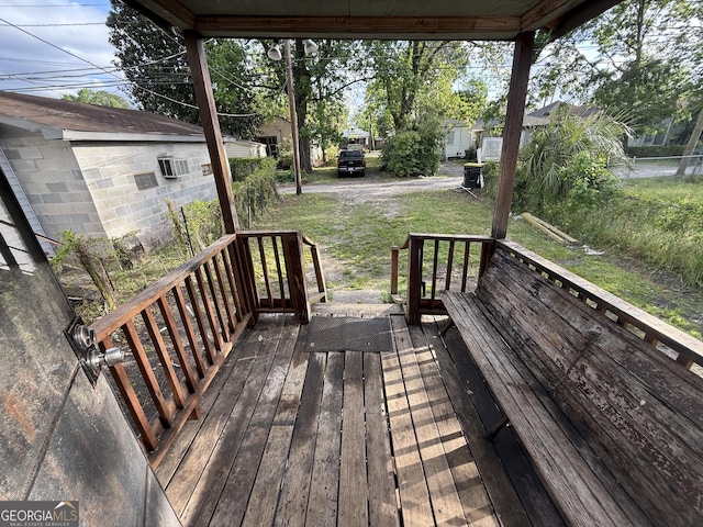 wooden terrace with a lawn