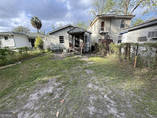 rear view of house featuring fence