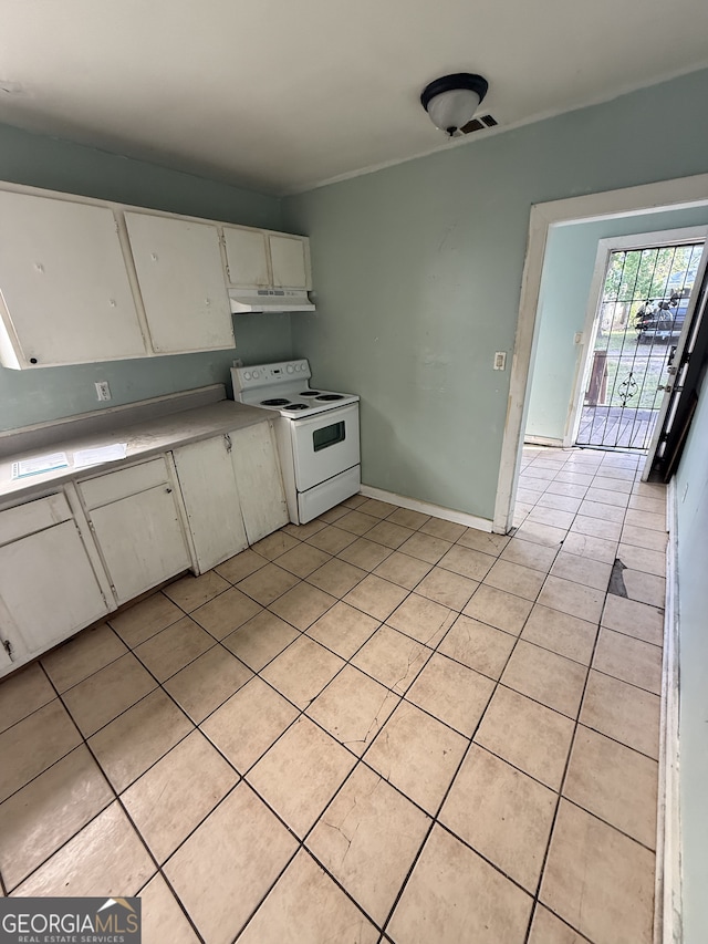 kitchen featuring white range with electric cooktop, light tile patterned flooring, under cabinet range hood, white cabinetry, and light countertops