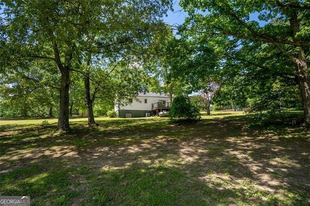view of yard featuring a wooden deck