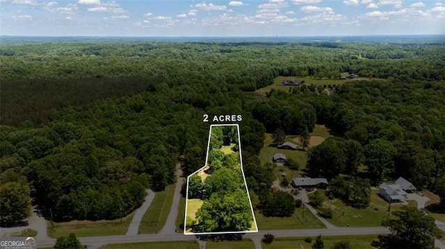 view of property location featuring a forest and property parcel outlined