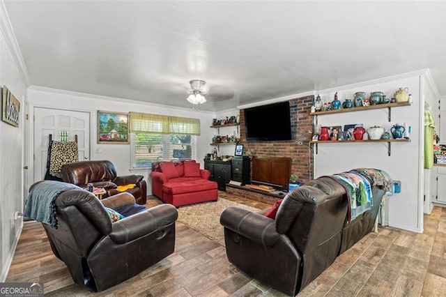 living room with crown molding, wood finished floors, and ceiling fan