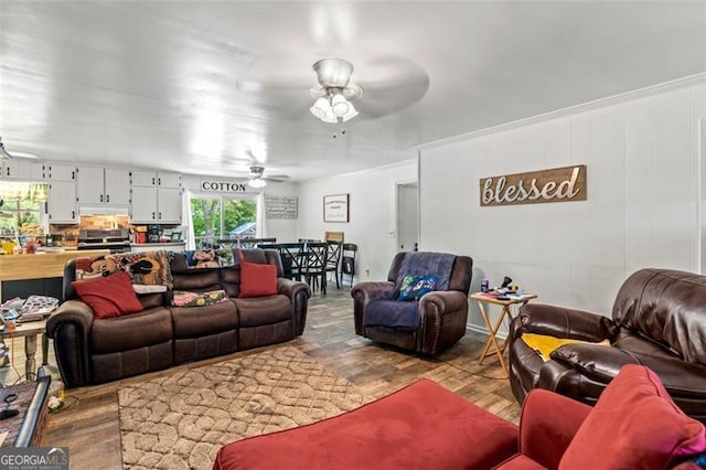 living room with wood finished floors and a ceiling fan