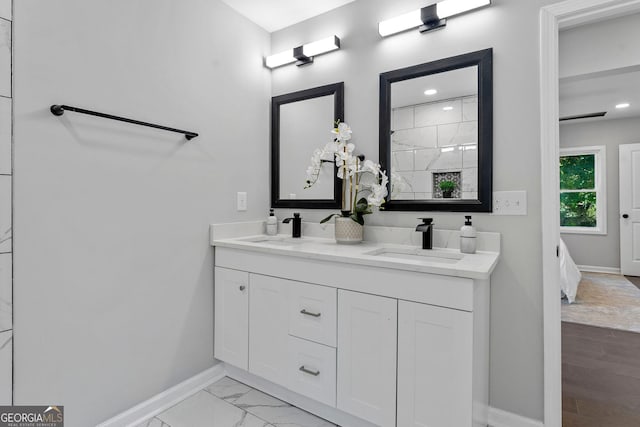 985 Columbia Dr, Decatur, GA 30030 - ensuite bathroom featuring baseboards, double vanity, marble finish floors, and recessed lighting