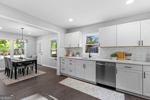 985 Columbia Dr, Decatur, GA 30030 - kitchen featuring stainless steel dishwasher, a sink, light countertops, baseboards, and recessed lighting