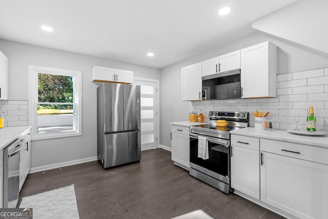 985 Columbia Dr, Decatur, GA 30030 - kitchen featuring stainless steel appliances, white cabinets, light countertops, backsplash, and recessed lighting