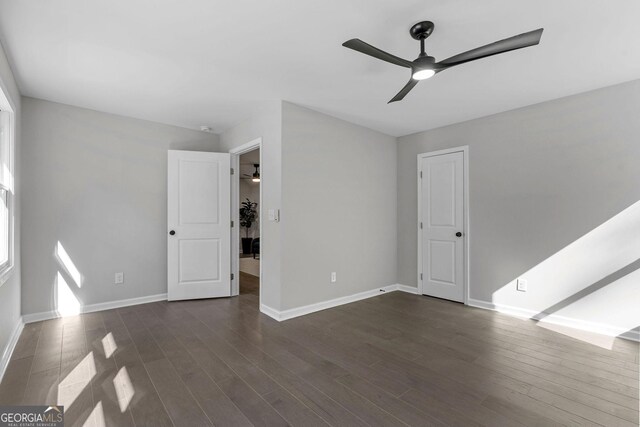 985 Columbia Dr, Decatur, GA 30030 - unfurnished living room featuring ceiling fan, dark wood-style floors, and baseboards