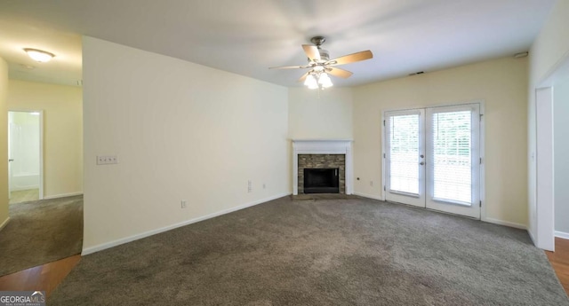 416 Clarion Dr, Carrollton, GA 30116 - unfurnished living room with a ceiling fan, a stone fireplace, and carpet floors
