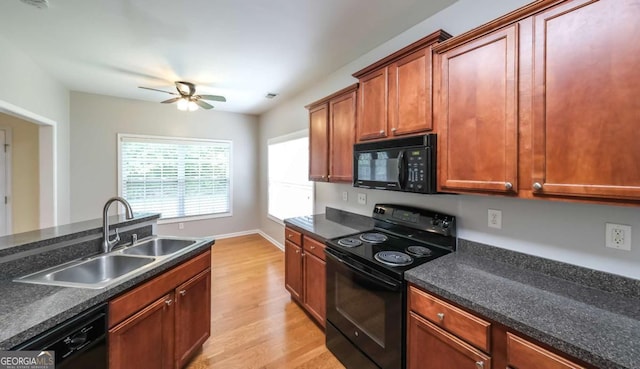 416 Clarion Dr, Carrollton, GA 30116 - kitchen with black appliances, a sink, light wood-style floors, a ceiling fan, and dark countertops