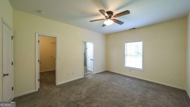 416 Clarion Dr, Carrollton, GA 30116 - unfurnished bedroom featuring a walk in closet, carpet flooring, baseboards, a ceiling fan, and ensuite bath