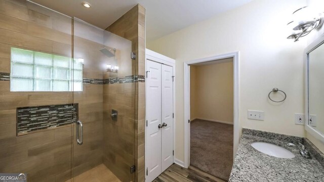416 Clarion Dr, Carrollton, GA 30116 - full bath with a shower stall, vanity, and wood finished floors