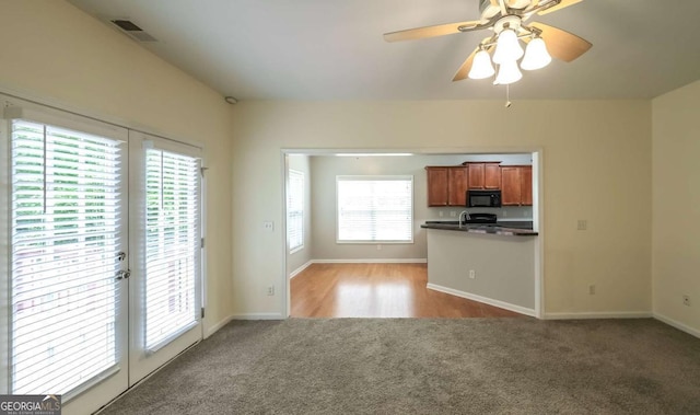 416 Clarion Dr, Carrollton, GA 30116 - unfurnished living room with light colored carpet, baseboards, and a ceiling fan