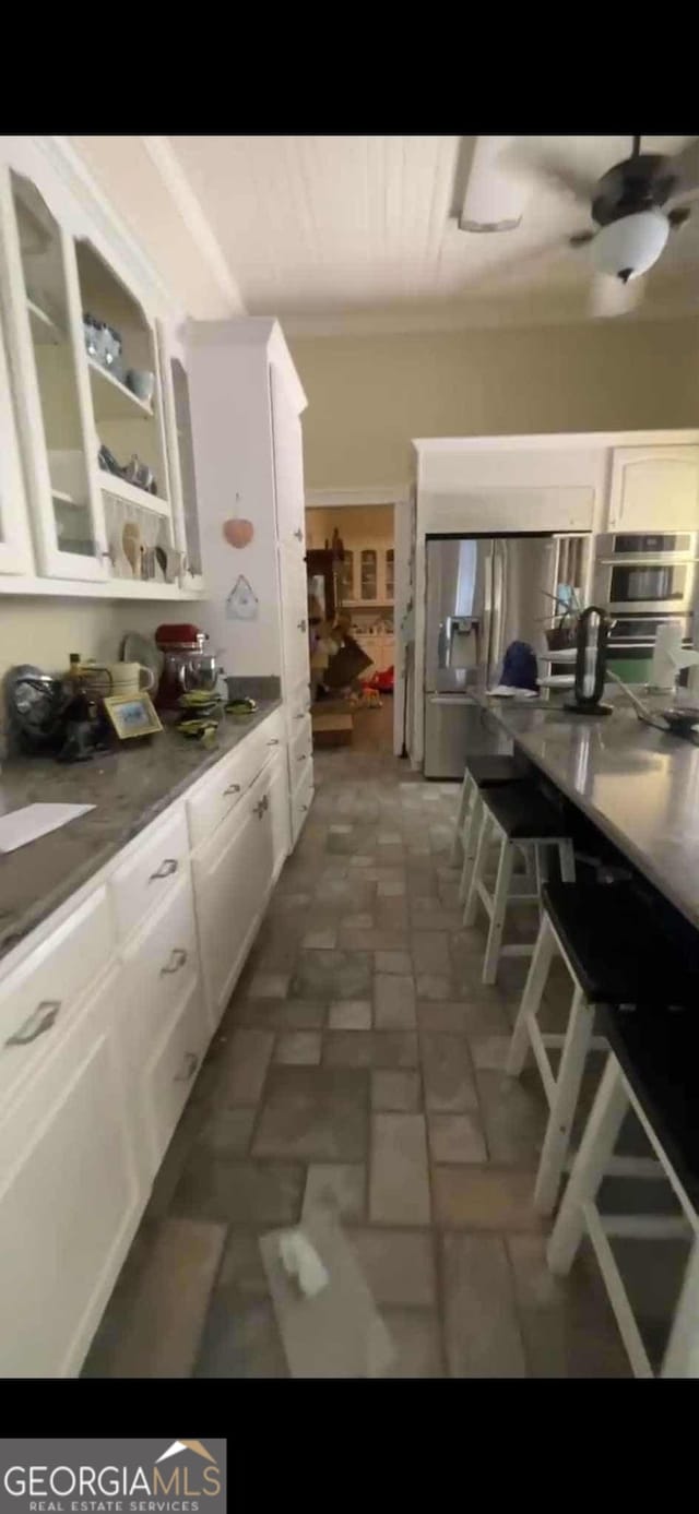 4922 Van Cise Ln, Albany, GA 31721 - kitchen with white cabinets, stainless steel appliances, and glass insert cabinets