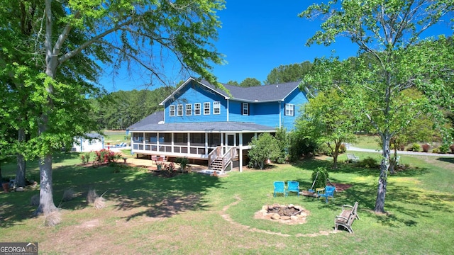 114 N Valhalla Dr, Cordele, GA 31015 - rear view of house with a sunroom, a fire pit, a yard, and roof with shingles