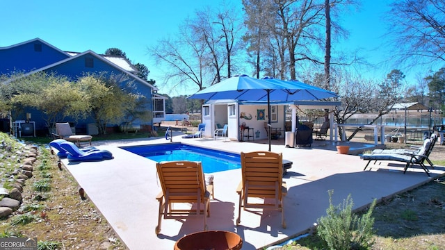 114 N Valhalla Dr, Cordele, GA 31015 - swimming pool featuring an outdoor structure, a patio, and a storage structure