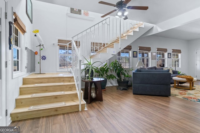 114 N Valhalla Dr, Cordele, GA 31015 - stairway featuring wood finished floors, ceiling fan, and a towering ceiling