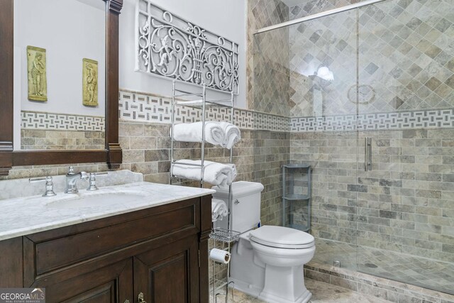 114 N Valhalla Dr, Cordele, GA 31015 - bathroom featuring a stall shower, toilet, vanity, and tile walls