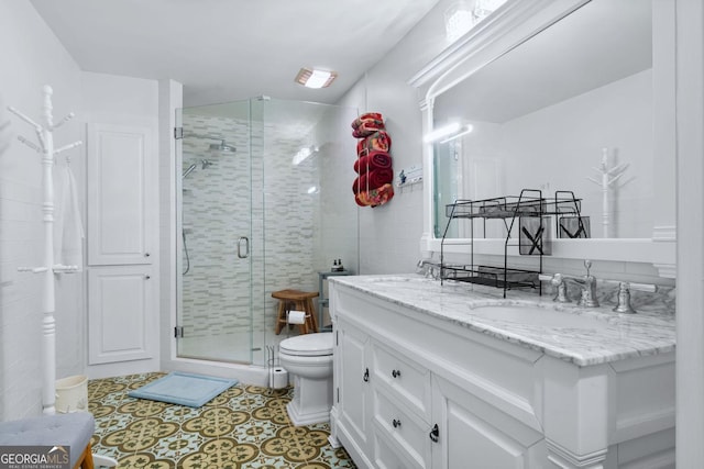114 N Valhalla Dr, Cordele, GA 31015 - full bathroom featuring a shower stall, toilet, double vanity, and tile patterned flooring