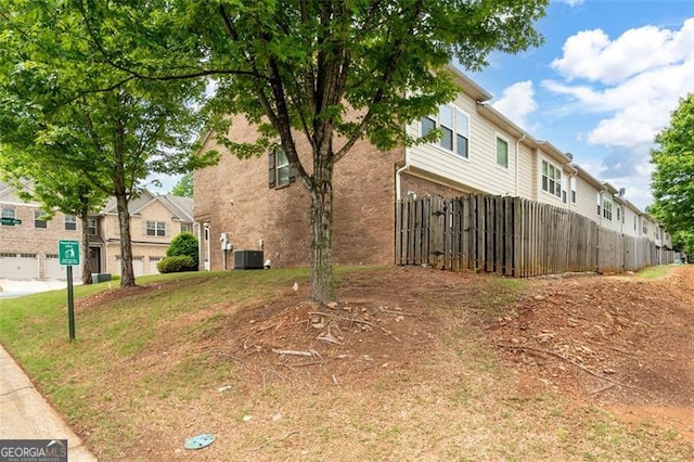 1957 Brightleaf Way Unit 59, Marietta, GA 30060 - view of property exterior with fence, brick siding, and central AC