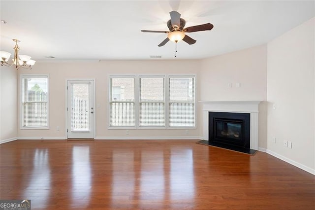 1957 Brightleaf Way Unit 59, Marietta, GA 30060 - unfurnished living room with wood finished floors, a chandelier, ceiling fan, a glass covered fireplace, and baseboards