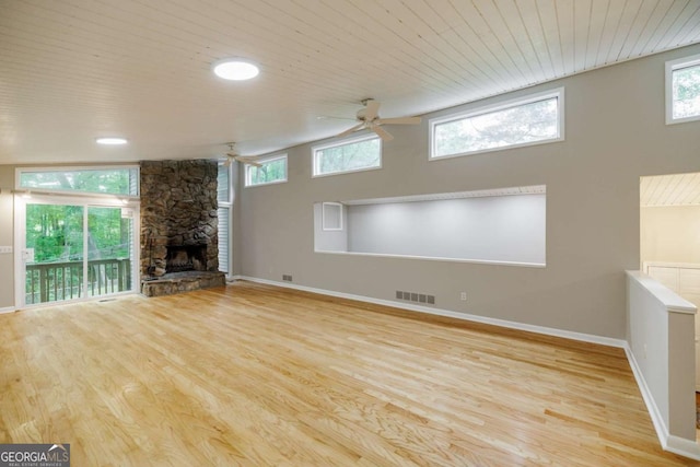 unfurnished living room with a ceiling fan, wood finished floors, a fireplace, baseboards, and wooden ceiling