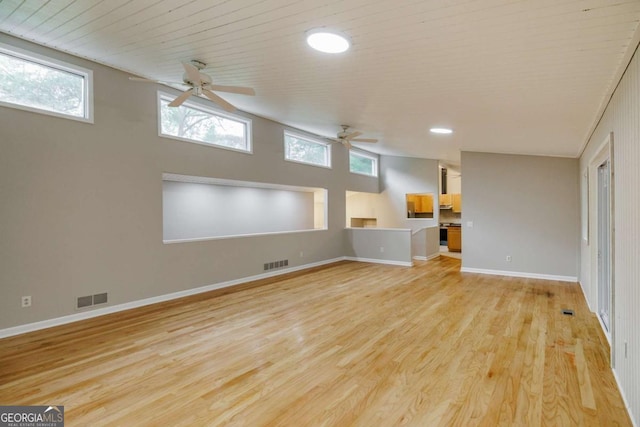 unfurnished living room featuring a ceiling fan, light wood finished floors, baseboards, and recessed lighting