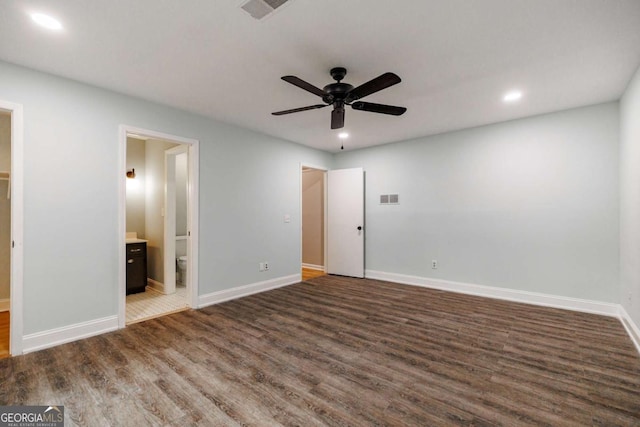 unfurnished bedroom featuring wood finished floors, recessed lighting, baseboards, connected bathroom, and ceiling fan
