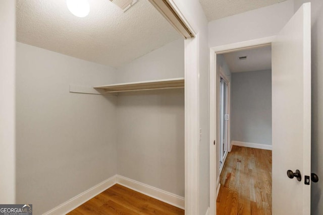 spacious closet featuring wood finished floors