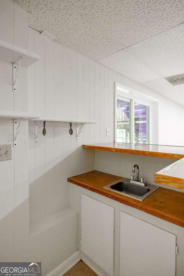 kitchen with a sink and white cabinetry