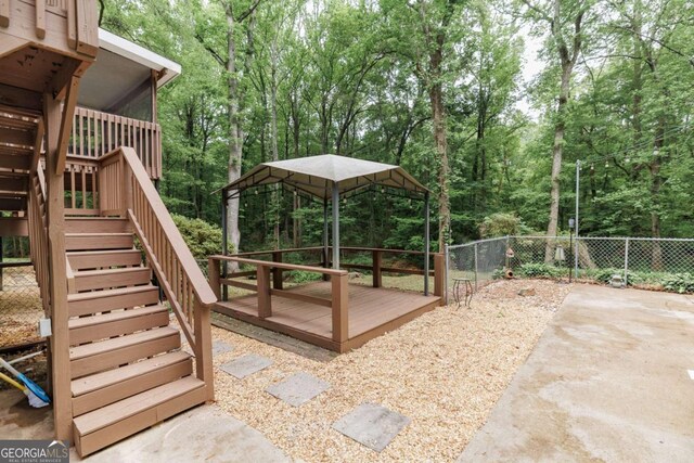 view of jungle gym with stairs, a fenced backyard, and a patio area