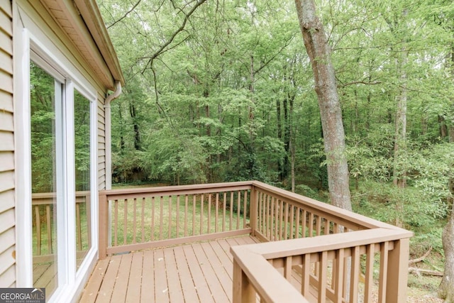wooden deck featuring a forest view